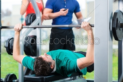Man and Personal Trainer in gym