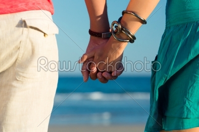 Man and woman enjoying sunset on beach