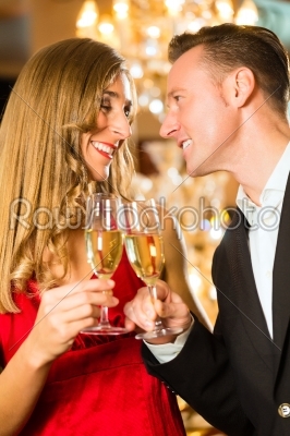 Man and woman tasting Champagne in restaurant