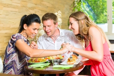man and women eating fresh salad for breakfast