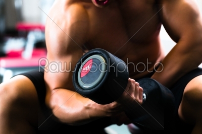 Man at Dumbbell training in gym