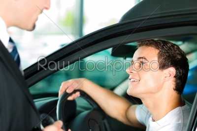 Man buying car from salesperson