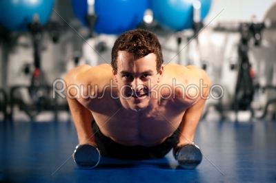 man doing pushups in gym