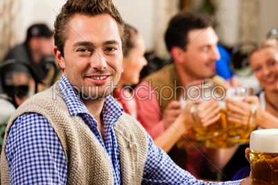 Man drinking beer in Bavarian pub