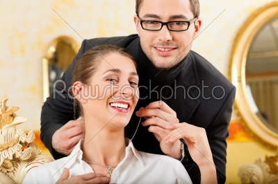 Man giving his wife a necklace