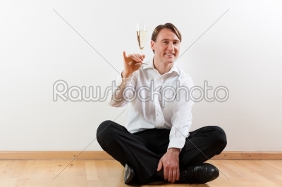 Man in apartment with champagne