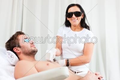 Man in cosmetic salon receiving waxing
