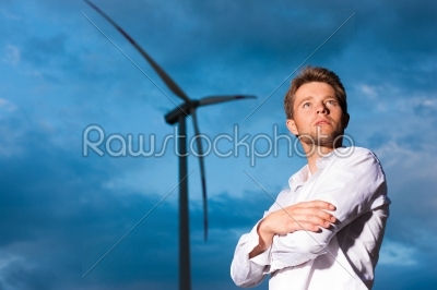 Man in front of windmill and sky