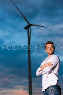 Man in front of windmill and sky