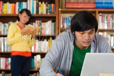 Man in library with laptop