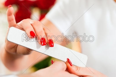 Man in nail salon receiving manicure
