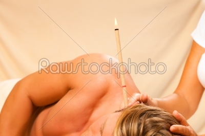Man in therapy with ear candles