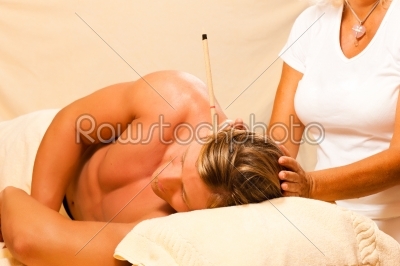 Man in therapy with ear candles