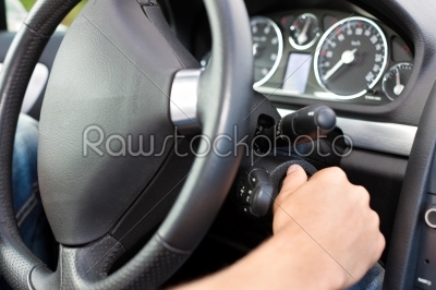 Man turning the ignition key of his car