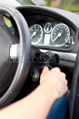 Man turning the ignition key of his car