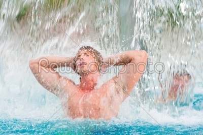 Man under water gadget in swimming pool