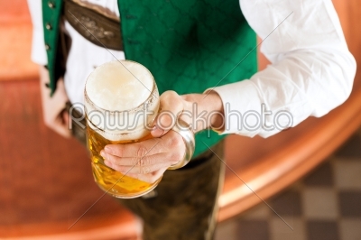 Man with beer glass in brewery