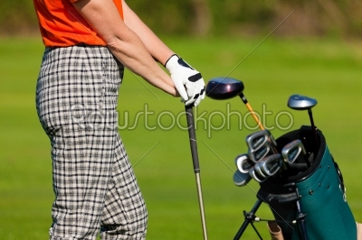 Mature Woman with golf bag playing golf