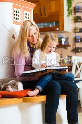 Mother reading night story to kid at home