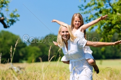 Mother with daugther in meadow