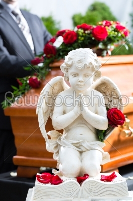 Mourning man at Funeral with coffin