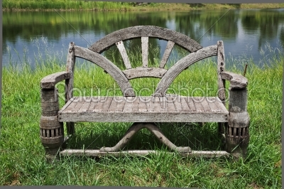 old empty recycle wooden bench near the lake in the park