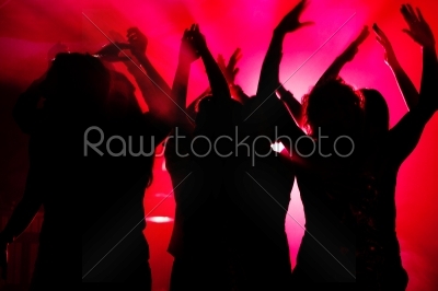 People dancing in club with lightshow