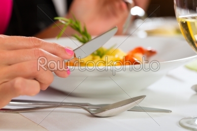 People fine dining in elegant restaurant