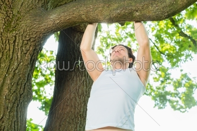 People in city park doing chins or pull ups