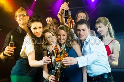 People in club or bar drinking beer