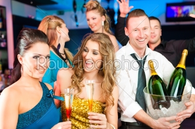 People in club or bar drinking champagne
