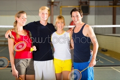 People in sport gym before badminton