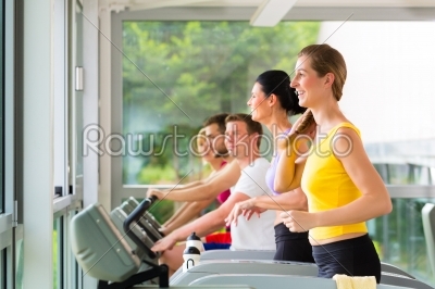 People in sport gym on treadmill running