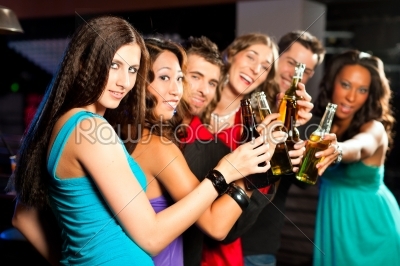 People with cocktails in bar or club