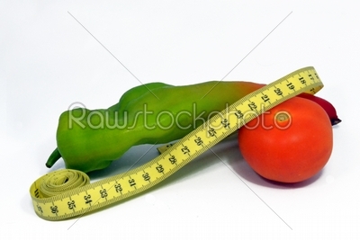 Pepper and tomato surrounded by a measuring tape