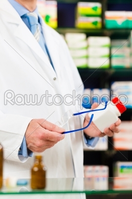 Pharmacist in pharmacy with medicament