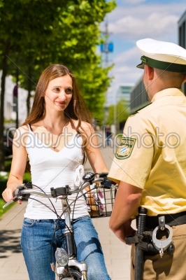 Police - woman on bicycle with police officer