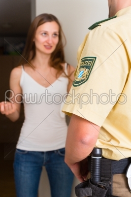 Police officer interrogation woman at front door