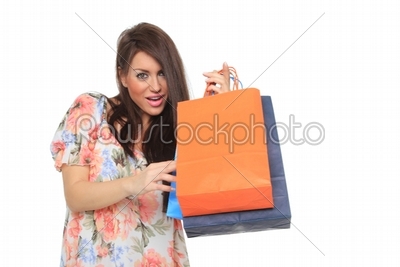 Portrait of stunning young woman carrying shopping bags