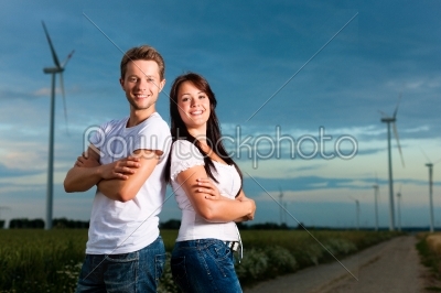Powerful couple in front of windmill 