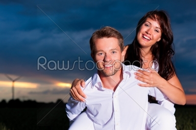 Powerful couple in front of windmill