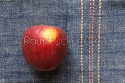 Red apple over blue cover 