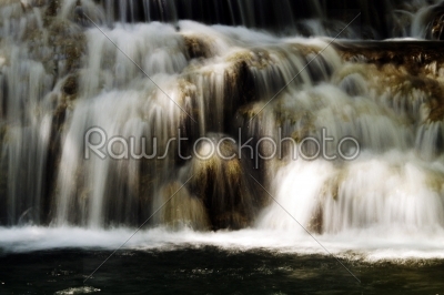 Scenic waterfall with white water cascading over rocks  