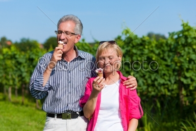 Senior couple having walk with ice cream