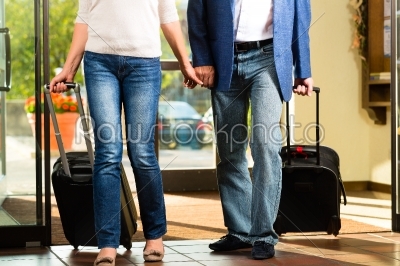 Senior married couple arriving at Hotel