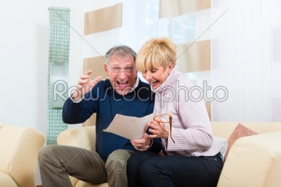 Seniors at home receiving a good letter