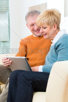 Seniors at home with tablet computer