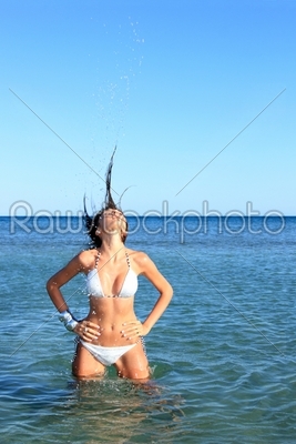 Sexy bikini model having fun in the ocean