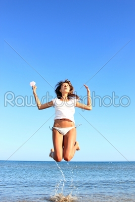 Sexy bikini model having fun in the ocean