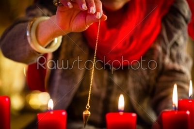 Soothsayer during a Seance or session with pendulum